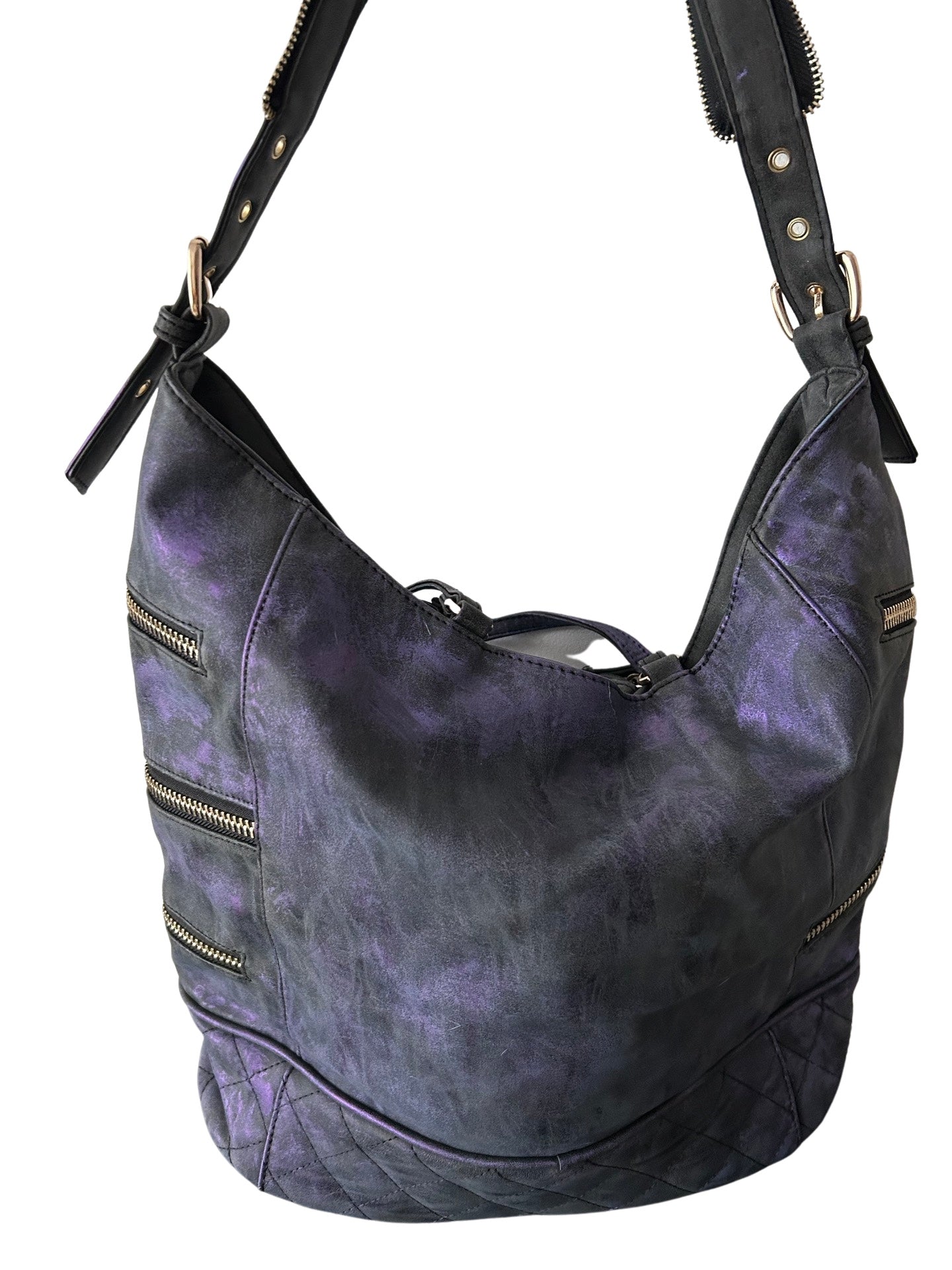 Purple leather handbag with zippers on a white background