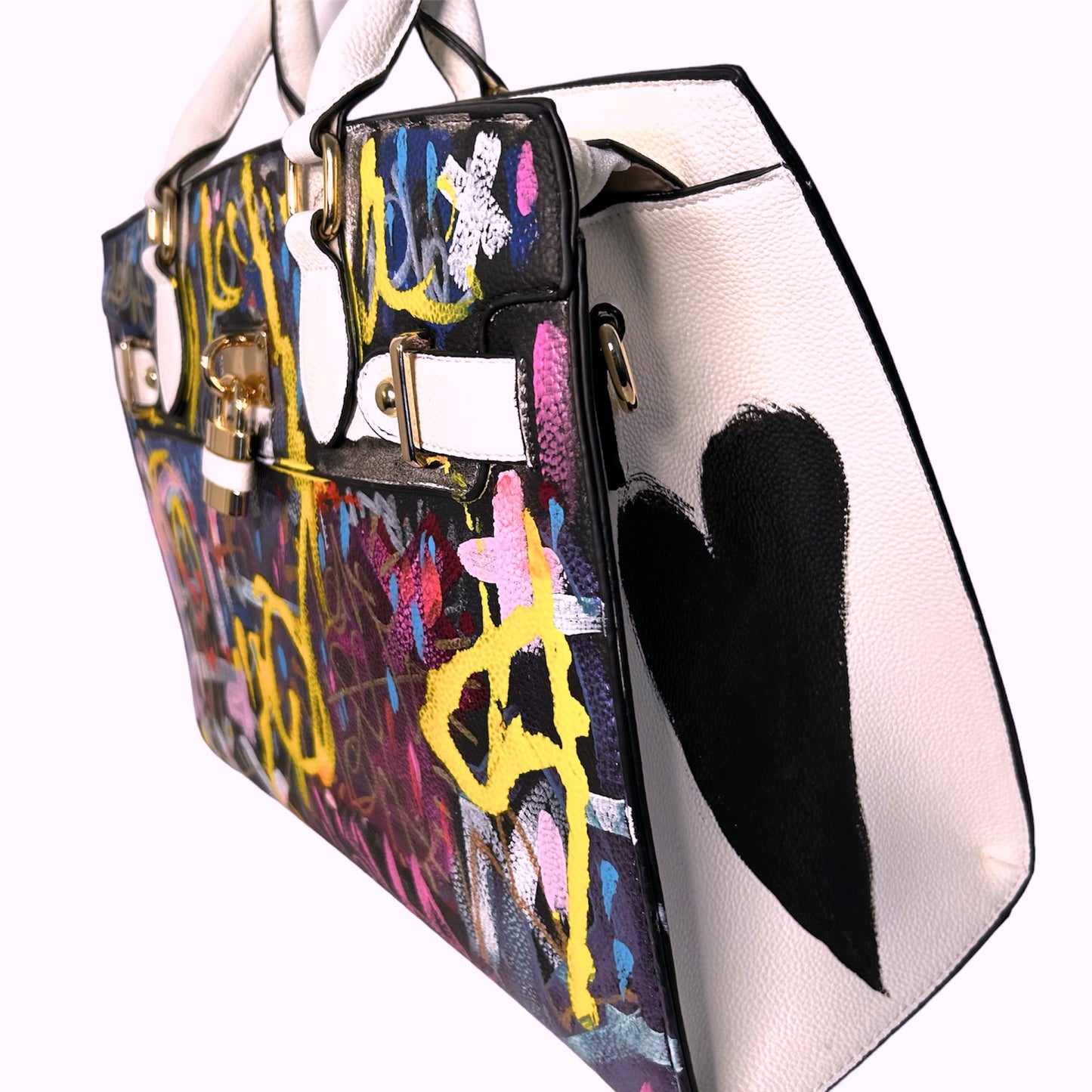 Colorful handbag with abstract design and black heart on a white background