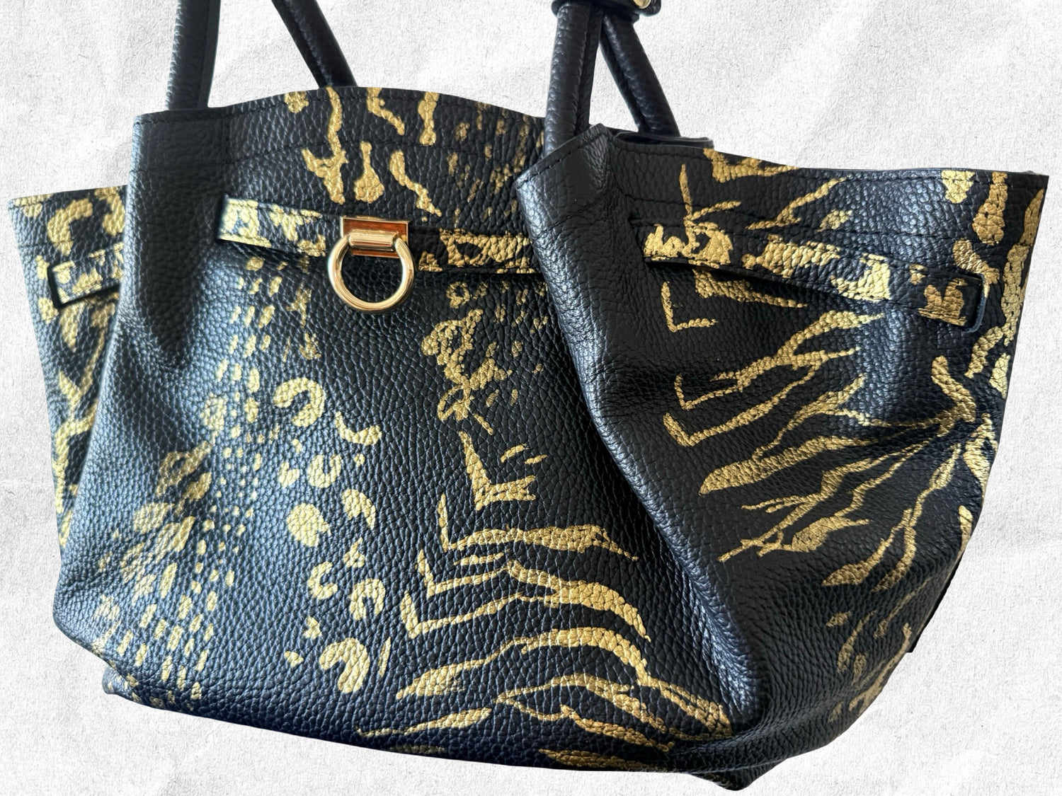 Exotic woman holding boho style denim handbag with gold sequins in Paris