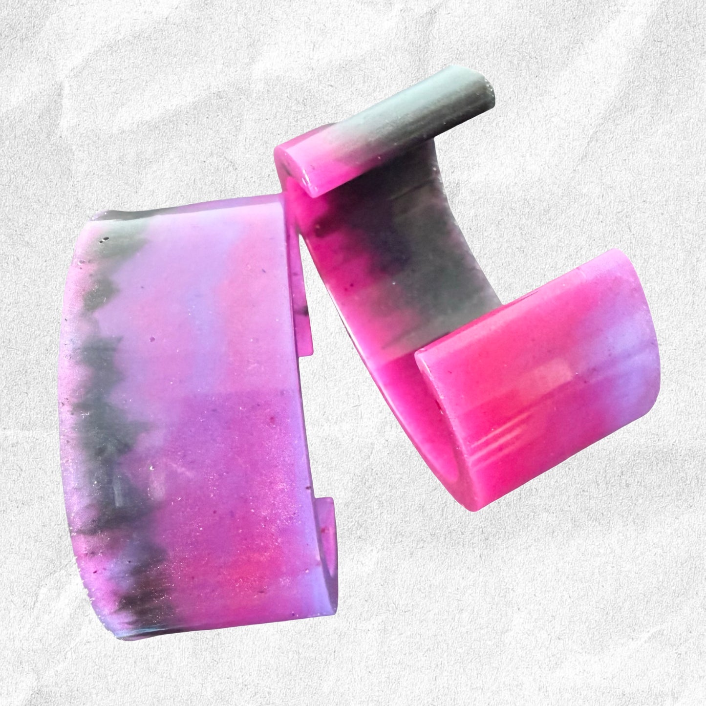 Colorful resin cuff bracelet on a light gray background