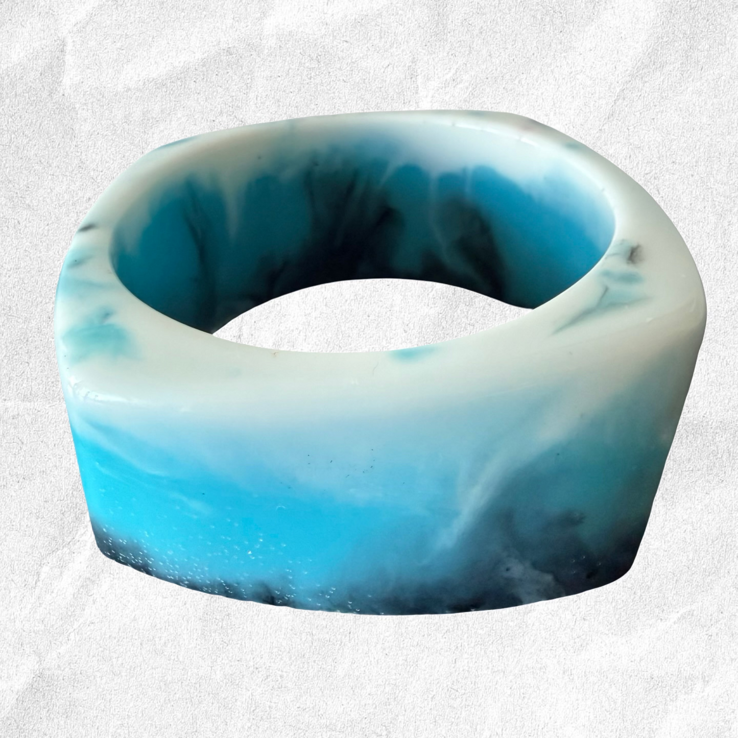 Blue and white marbled bracelet on a light gray background