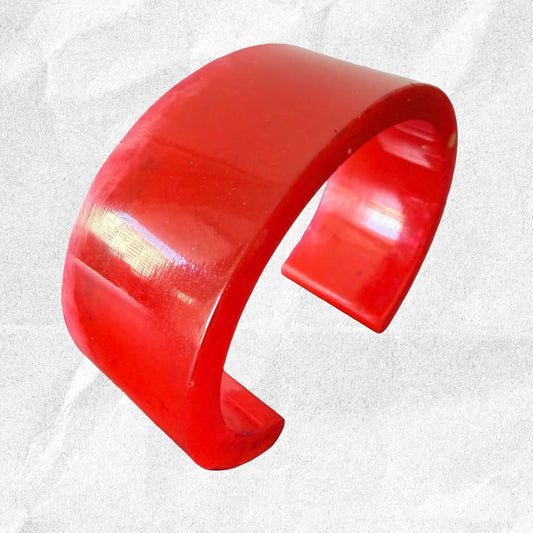 Red resin bracelet on a white background