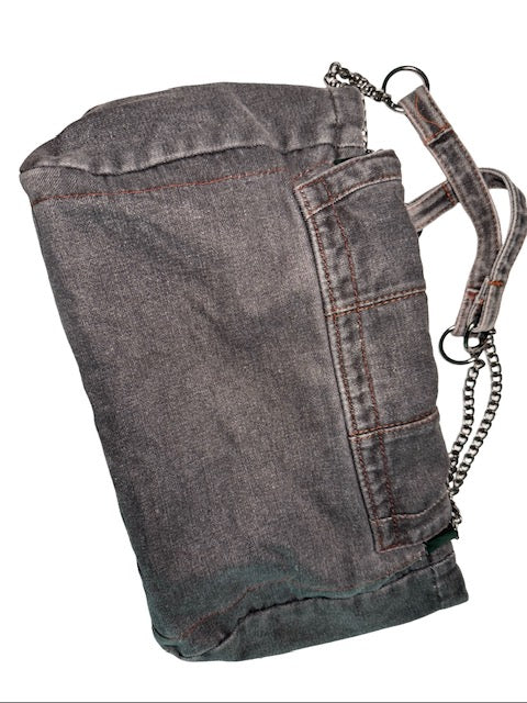 Denim bag with a chain detail on a white background