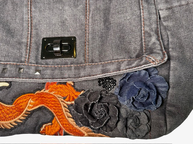 Gray denim bag with floral embroidery and a black metal clasp.