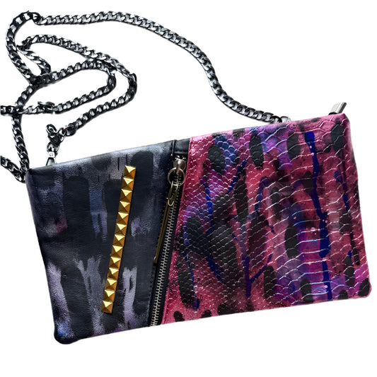 Multicolored patterned clutch bag with chain strap on a white background
