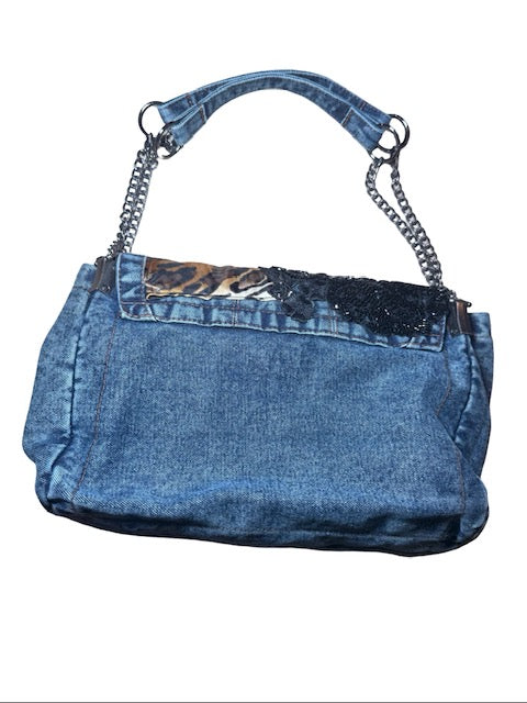 Blue denim handbag with chain handle on a white background