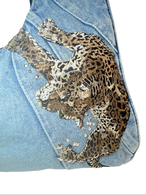 Leopard print design on a denim fabric background