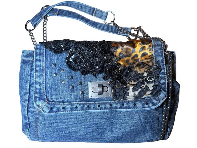 Denim handbag with decorative elements on a white background