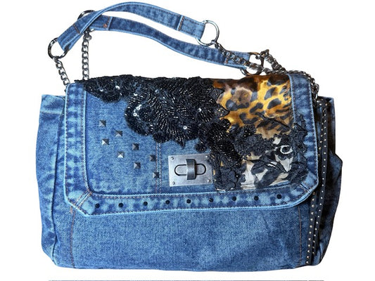 Denim handbag with decorative elements on a white background