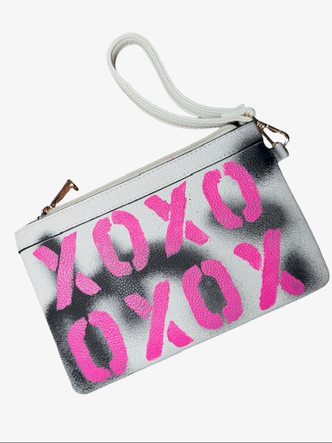Pouch with pink 'XOXO' text on a white background