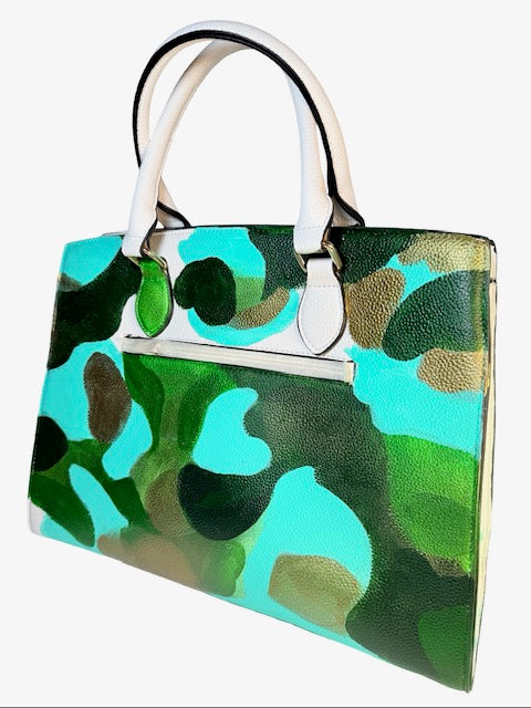 Camouflage-patterned handbag with a white handle on a white background