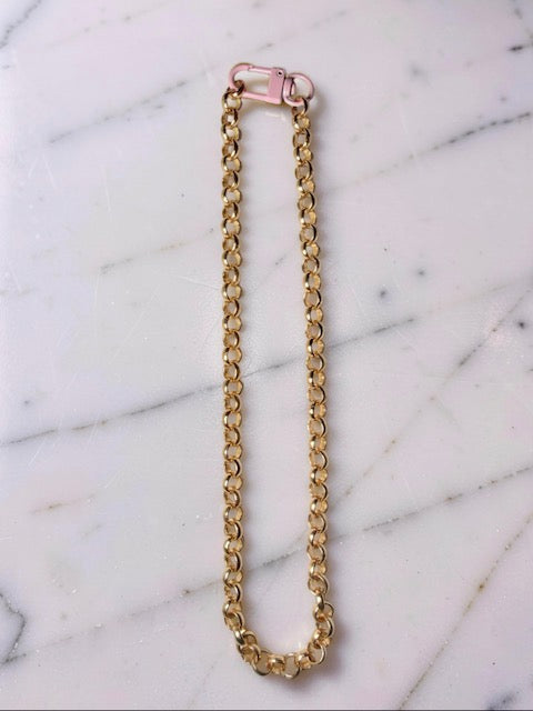 Gold chain necklace on a marble surface