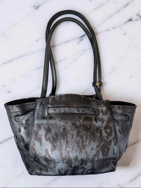 Black and gray patterned tote bag on a marble surface