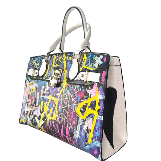 Colorful graffiti-style handbag with a white handle on a light gray background